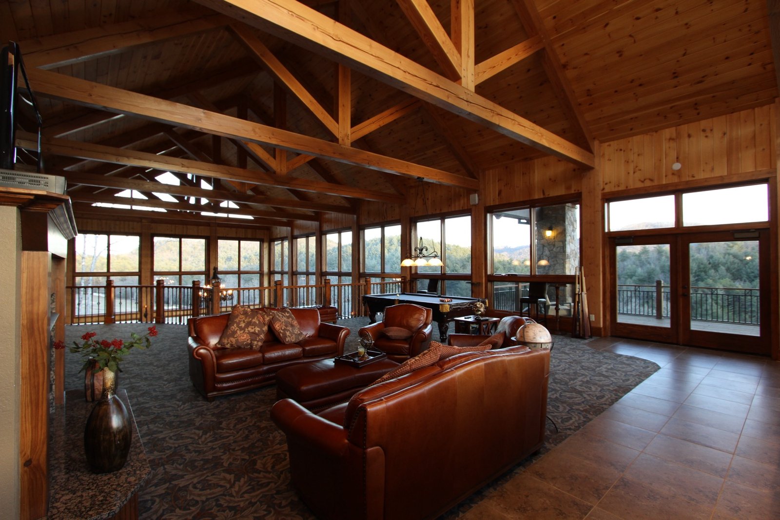 Clubhouse great room with timber trusses and leather seating